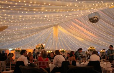 Wedding Interior with white marquee roof a disco ball and fairy lights 2