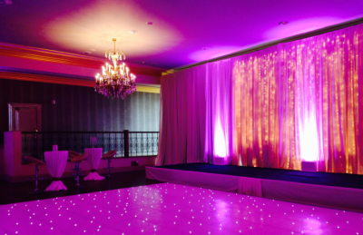 wedding hotel interiors with white dancefloor and pink light backdrop