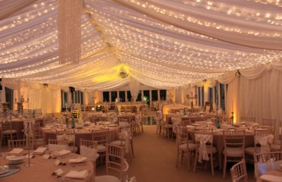 Wedding Interior with white marquee roof a disco ball and fairy lights