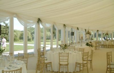 Marquee wedding interiors with white drapery and casement